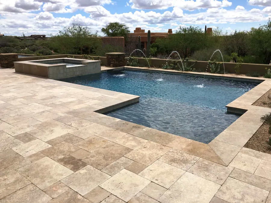 Rectangular pool with a raised spa and a row of arcing fountains